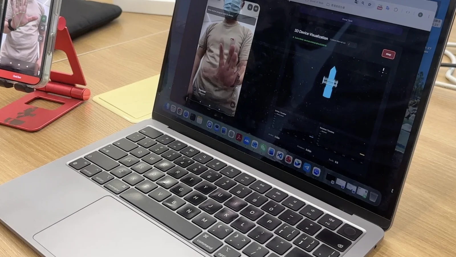 A phone and laptop running Pulsar software integration tests with live hand tracking and a synchronized device visualization